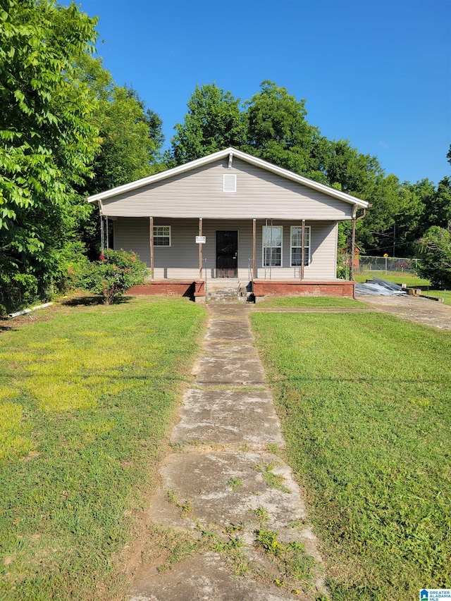 view of front of property with a front yard and covered porch