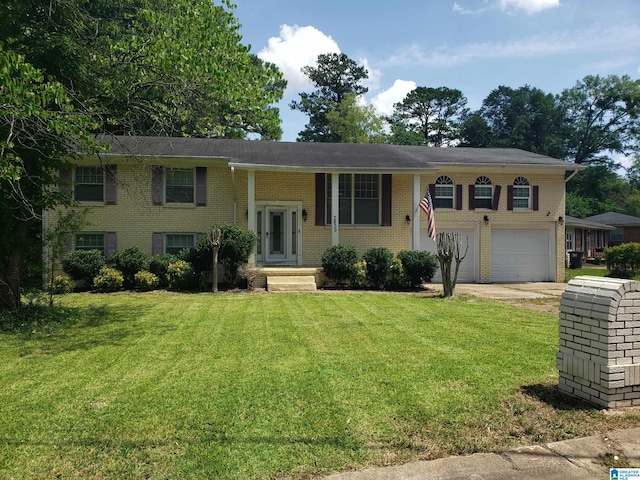 split foyer home featuring a front lawn and a garage