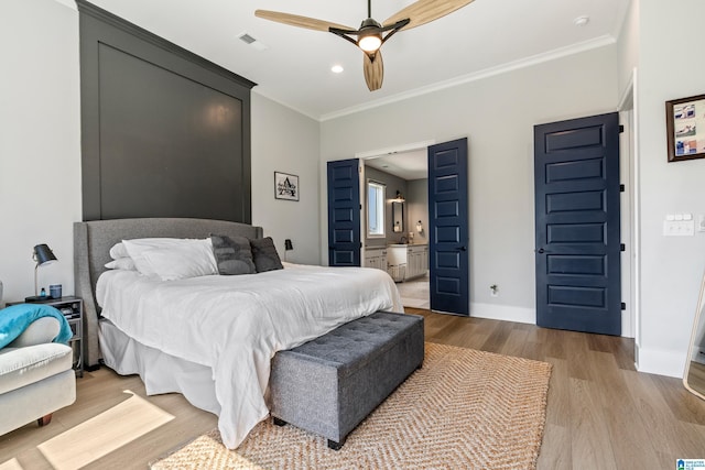 bedroom featuring crown molding, ensuite bathroom, ceiling fan, and light hardwood / wood-style flooring