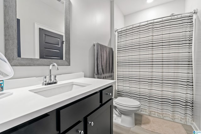 bathroom with vanity, a shower with curtain, and toilet