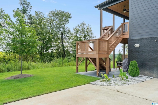 view of yard with ceiling fan and a patio area