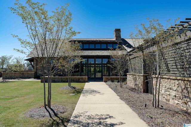 view of front of home with a front yard and french doors