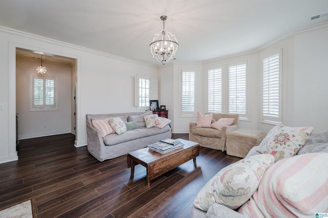 living room with dark wood-type flooring, a chandelier, and a healthy amount of sunlight