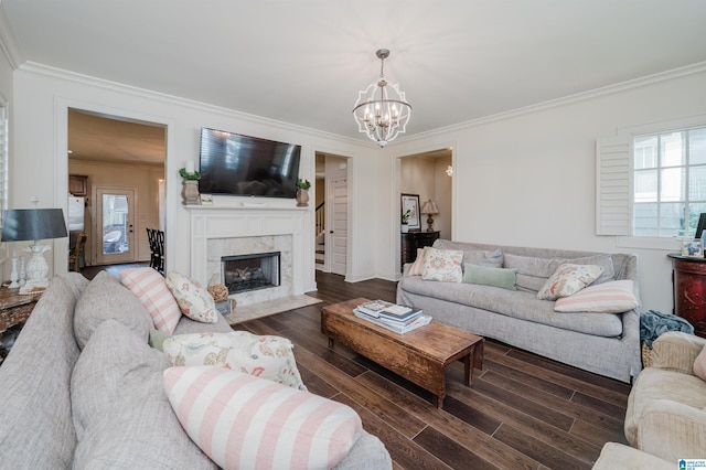 living room with dark wood-type flooring, ornamental molding, and a fireplace