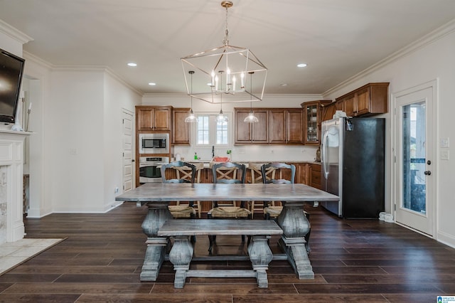 dining room featuring sink and crown molding