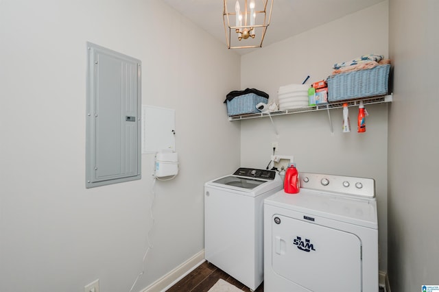 laundry area featuring washer and clothes dryer, dark wood-type flooring, electric panel, and an inviting chandelier