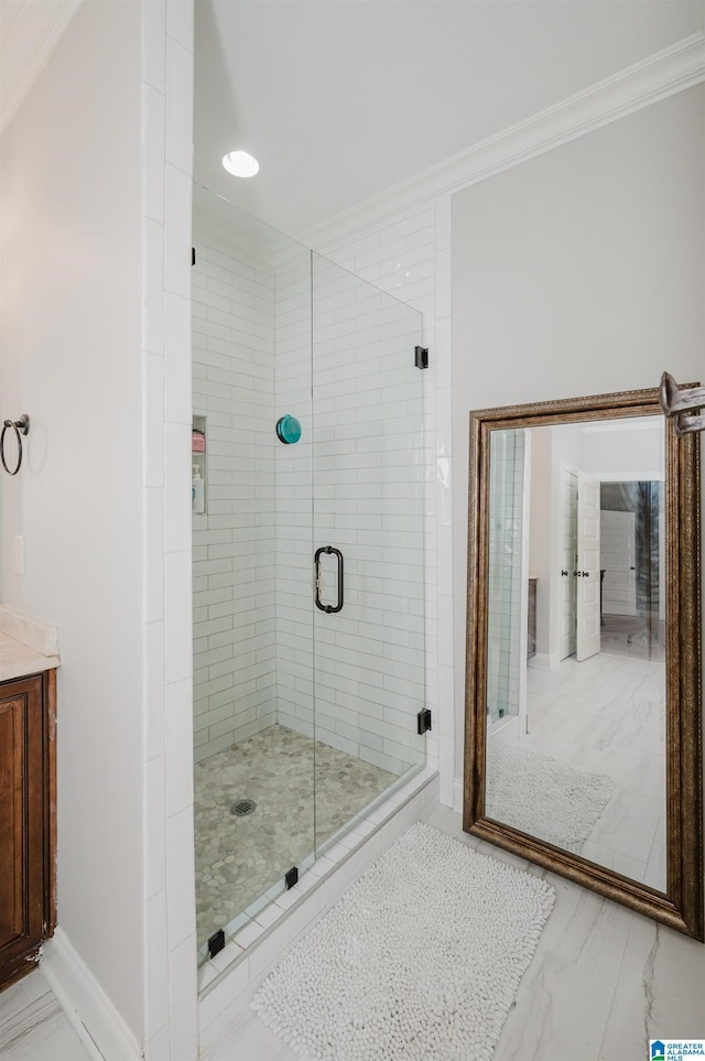 bathroom featuring a shower with door and crown molding