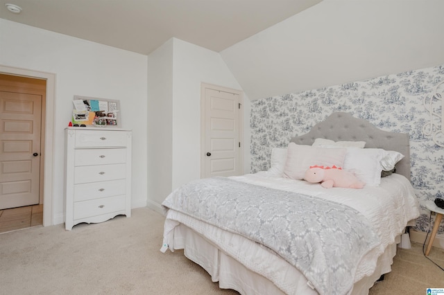 bedroom with light carpet and vaulted ceiling