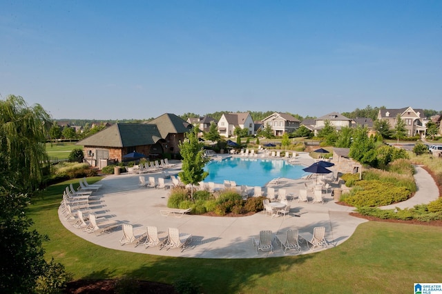 view of swimming pool with a patio area and a yard