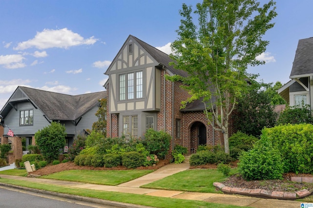 english style home with a front yard