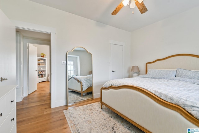 bedroom with ceiling fan and light wood-type flooring