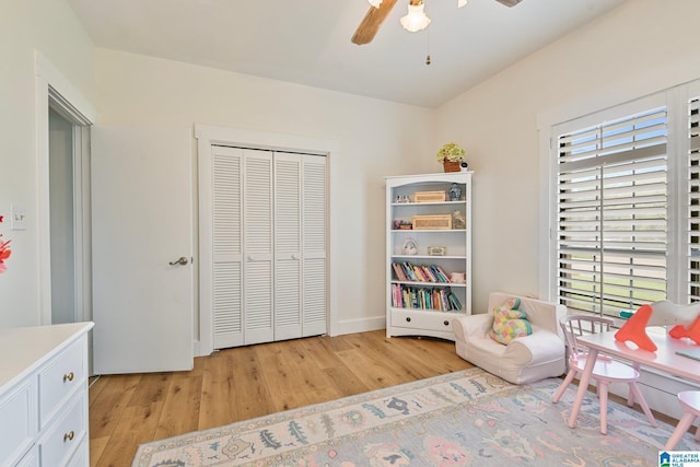 recreation room with light hardwood / wood-style floors and ceiling fan