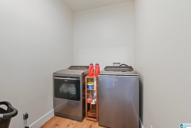 washroom featuring light hardwood / wood-style flooring and washing machine and dryer