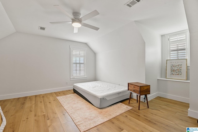 bedroom featuring lofted ceiling, light wood-type flooring, and ceiling fan