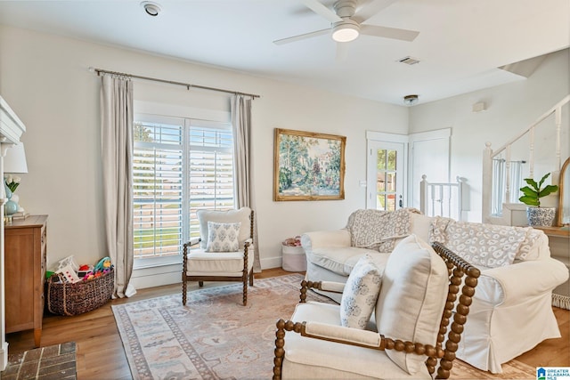 living room with light hardwood / wood-style floors and ceiling fan