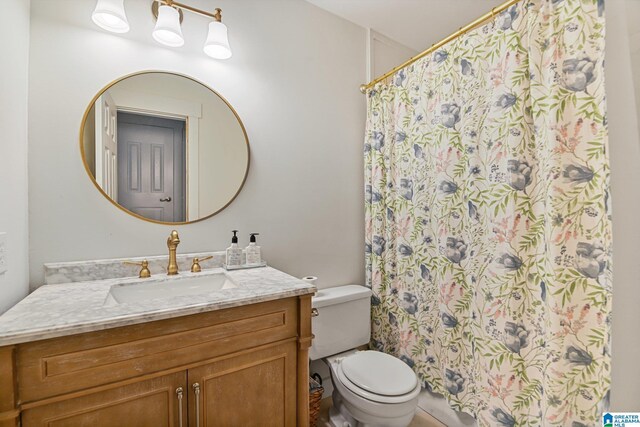 bathroom featuring toilet and vanity