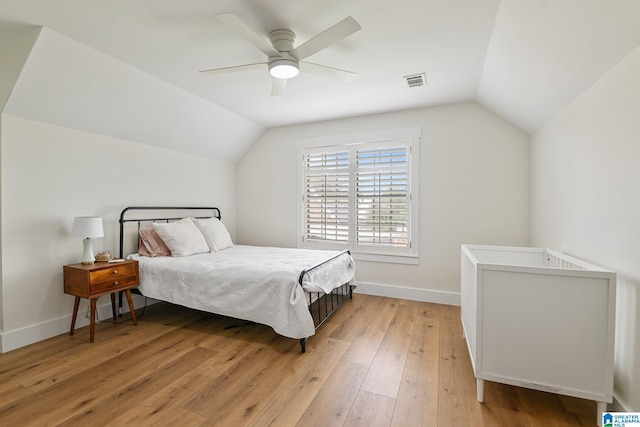 bedroom featuring lofted ceiling, ceiling fan, and light wood-type flooring