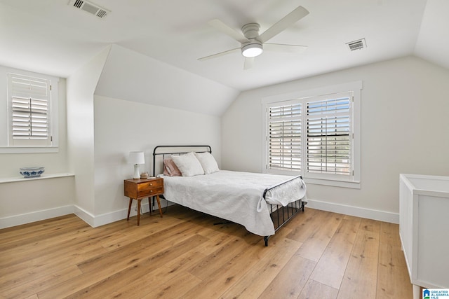 bedroom featuring lofted ceiling, light wood-type flooring, and ceiling fan