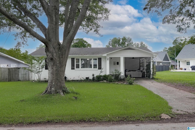 ranch-style house with a carport and a front yard