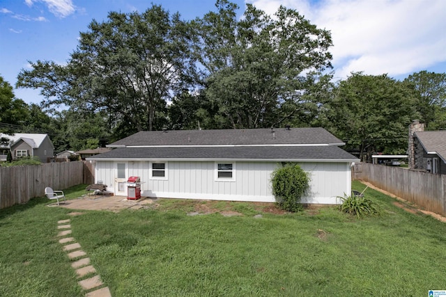 rear view of property with a yard