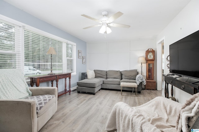 living room with ceiling fan and light hardwood / wood-style flooring