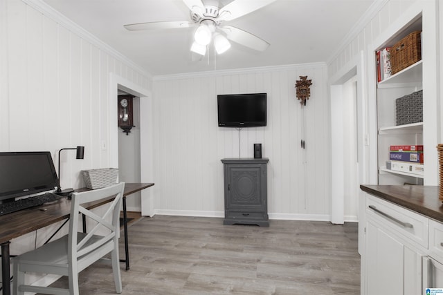 office with light hardwood / wood-style floors, ornamental molding, and ceiling fan