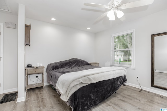 bedroom with ceiling fan and light hardwood / wood-style flooring