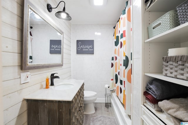 full bathroom with vanity, toilet, wood-type flooring, and shower / bath combo