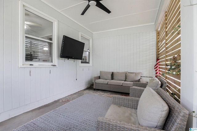 living room featuring concrete flooring and ceiling fan