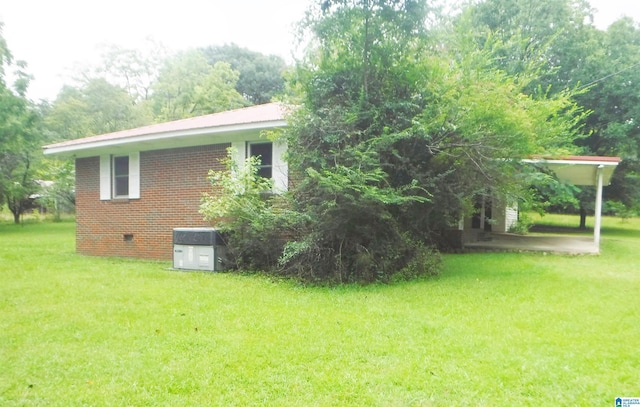 view of property exterior with cooling unit and a yard