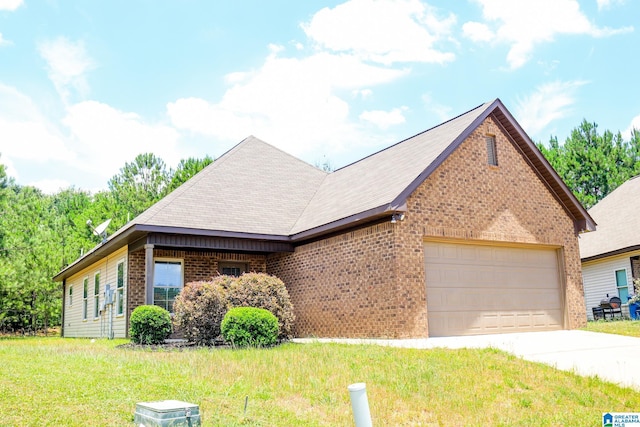 view of front of house with a garage and a front lawn