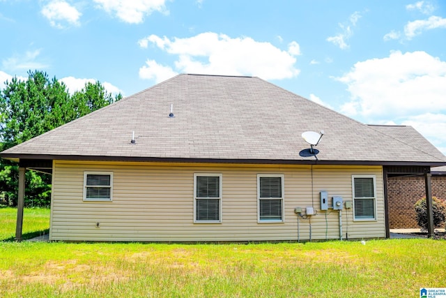 rear view of property with a yard