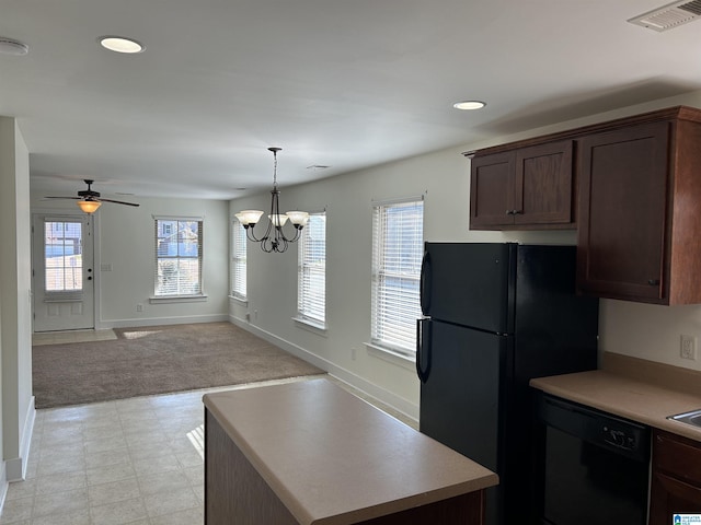 kitchen featuring dark brown cabinetry, decorative light fixtures, light carpet, ceiling fan with notable chandelier, and black appliances