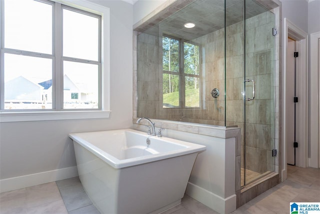 bathroom with tile patterned floors and separate shower and tub