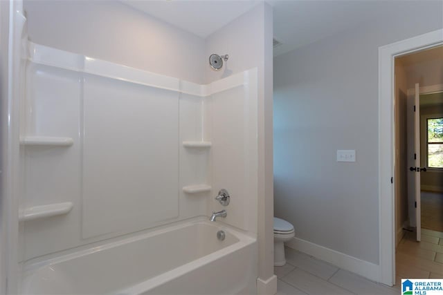 bathroom with shower / tub combination, toilet, and tile patterned flooring