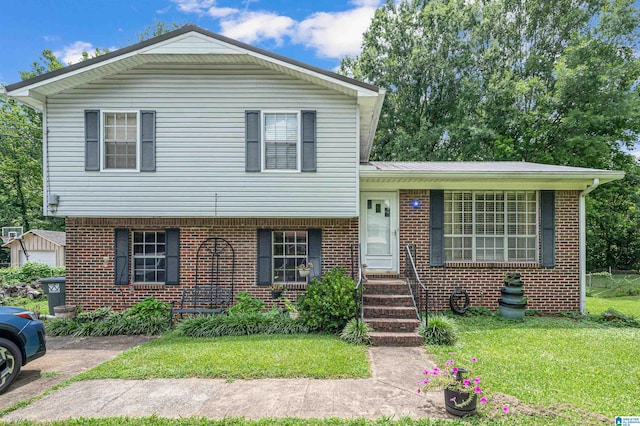 tri-level home with a garage and a front yard