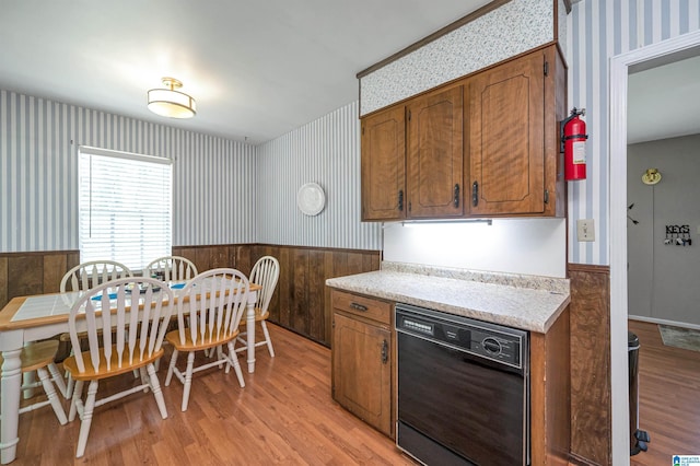 kitchen with dishwasher and light hardwood / wood-style flooring