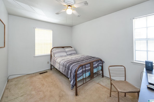 bedroom with light carpet and ceiling fan