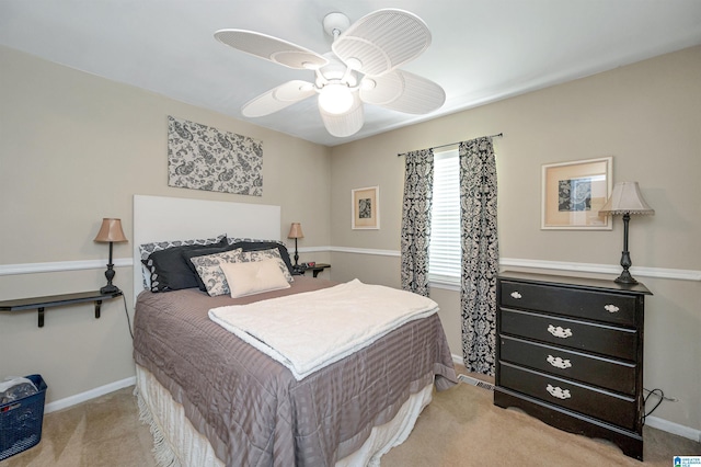 bedroom with ceiling fan and light carpet