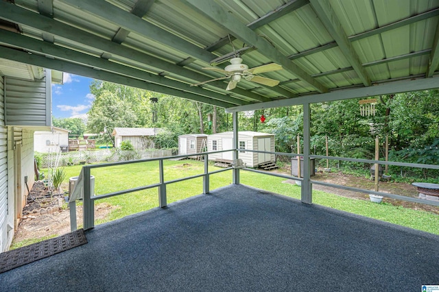 unfurnished sunroom with ceiling fan