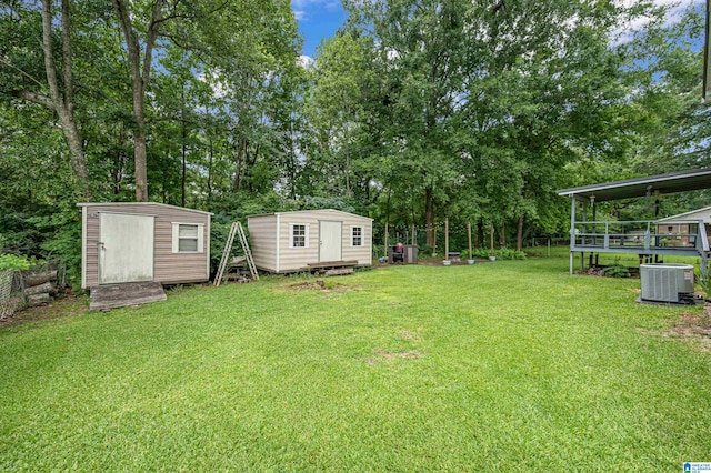 view of yard with central AC and a storage unit