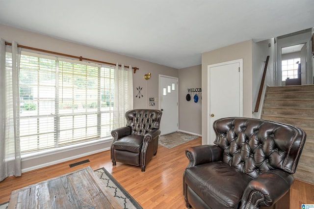 sitting room with a wealth of natural light and wood-type flooring