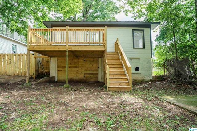 rear view of property featuring a wooden deck