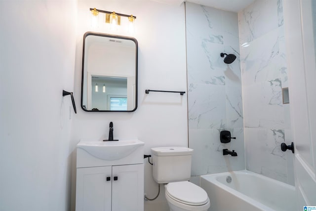 full bathroom with vanity, tiled shower / bath, and toilet