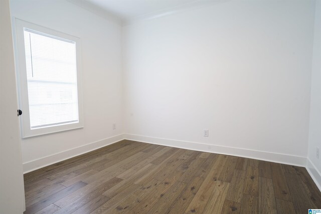 spare room featuring hardwood / wood-style floors and ornamental molding