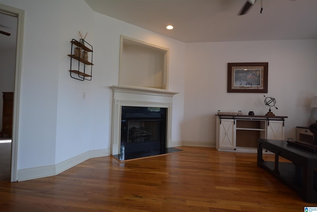 living room with wood-type flooring and ceiling fan