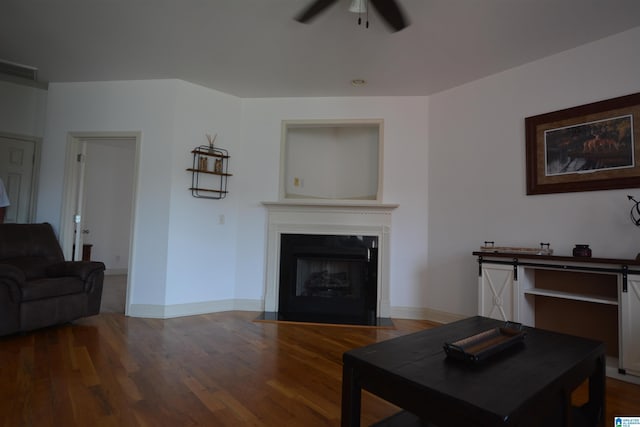 living room featuring hardwood / wood-style floors and ceiling fan