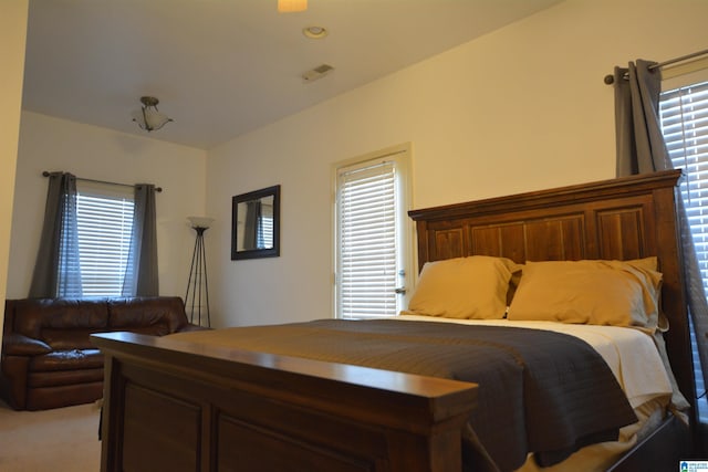 bedroom featuring light colored carpet