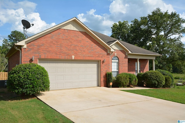 view of front of property featuring central AC unit, a garage, and a front yard