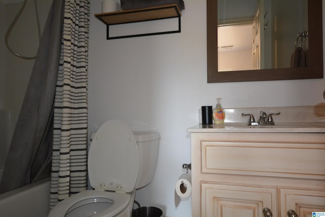 full bathroom with vanity, shower / tub combo with curtain, and toilet